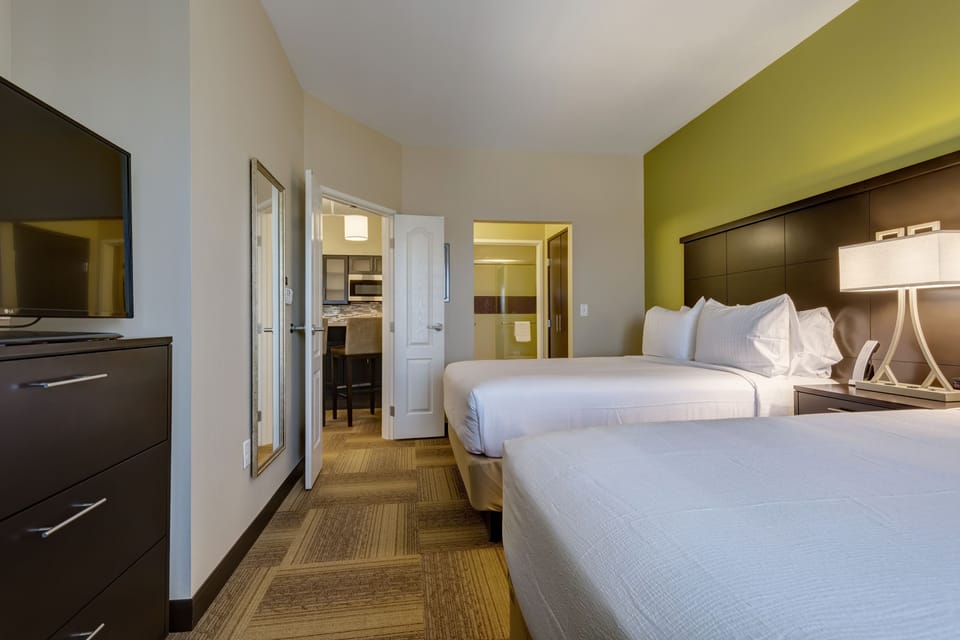 Premium bedding, desk, laptop workspace, iron/ironing board