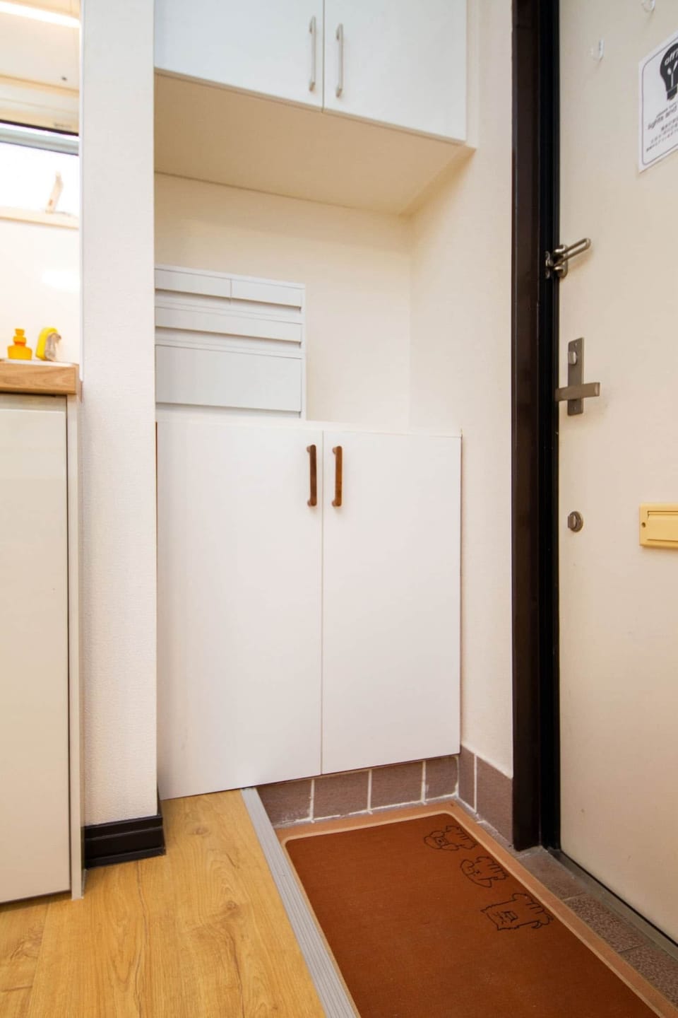 Handy shoe cabinet keeps the entry clean and organised.