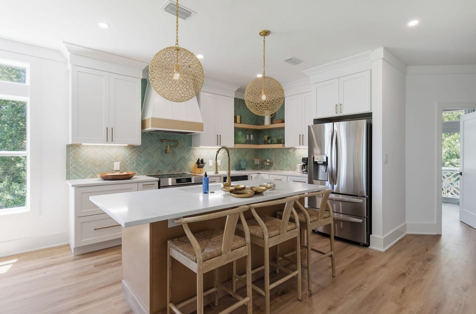 A newly renovated kitchen with stainless appliances and a large island for gathering.