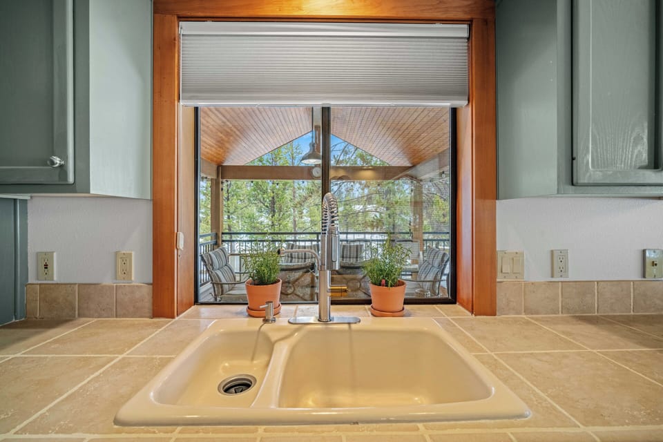 Your kitchen sink overlooks a charming covered patio where you can unwind with morning coffee or evening relaxation.