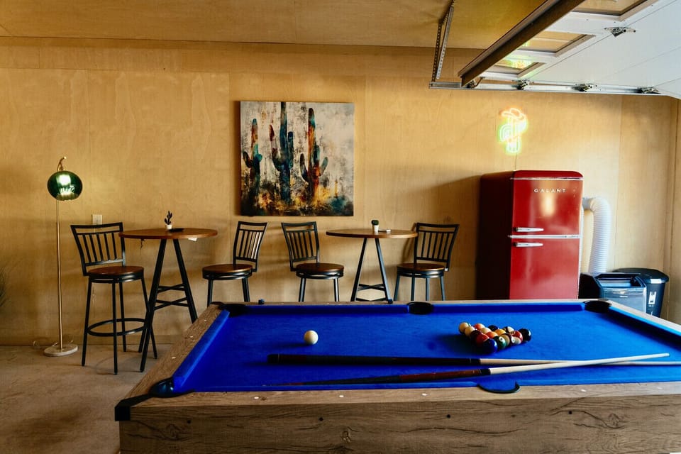 Your private game room awaits with a vintage pool table, retro fridge stocked with drinks, and cozy seating for unforgettable evenings.