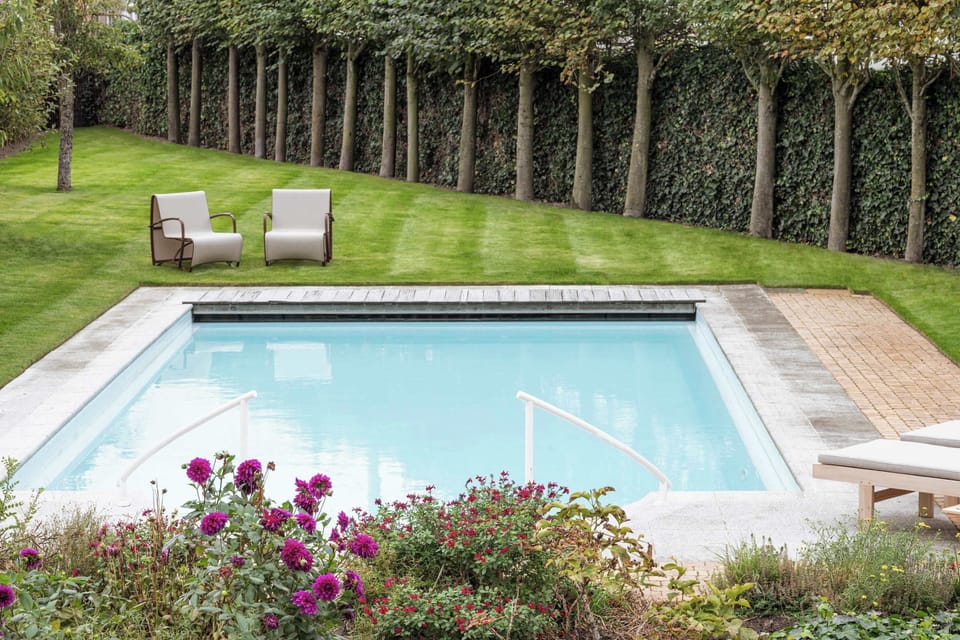 Bright swimming pool framed by vibrant blooms