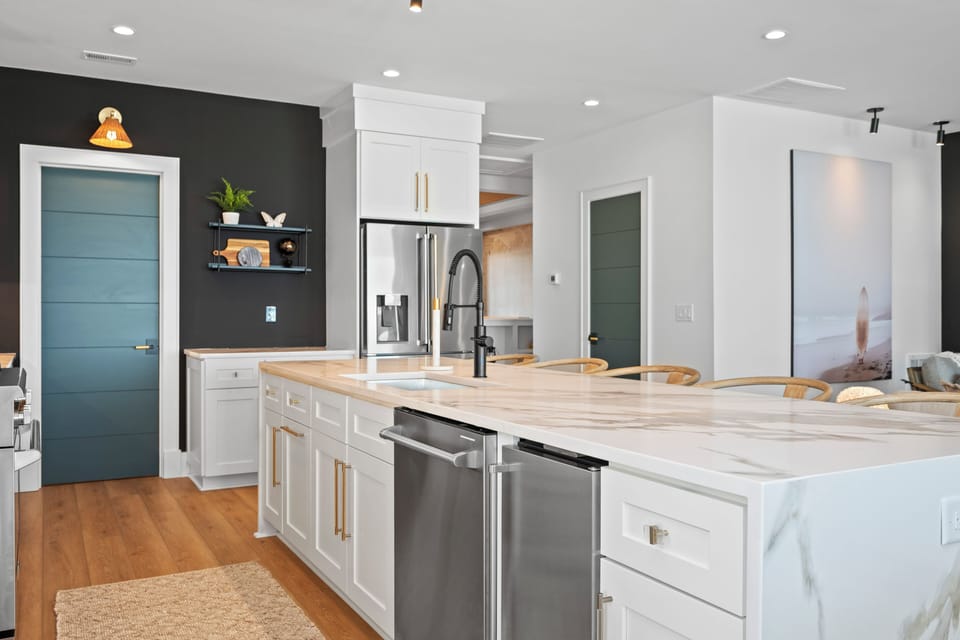 Your stylish kitchen awaits with marble counters, modern appliances, and warm wood floors for memorable meal preparation.