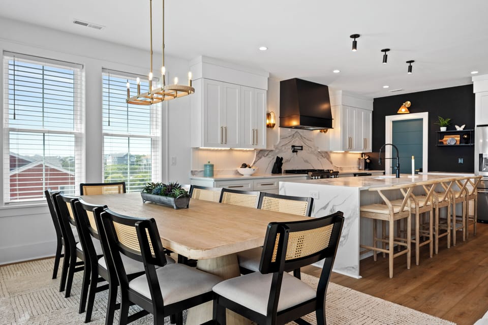 You'll love gathering in this stunning open kitchen and dining space featuring marble countertops, modern fixtures, and elegant seating for memorable meals.