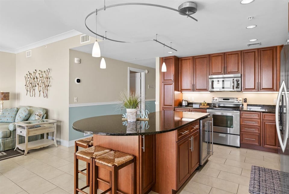 This Kitchen features warm wood cabinetry and stainless steel appliances.