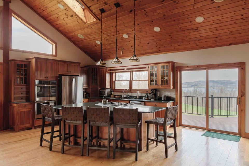 A chef’s dream, this full kitchen makes cooking for your entire crew (or team) a breeze. Located on the main floor next to the living room and directly off the wrap around deck with views of the lake.