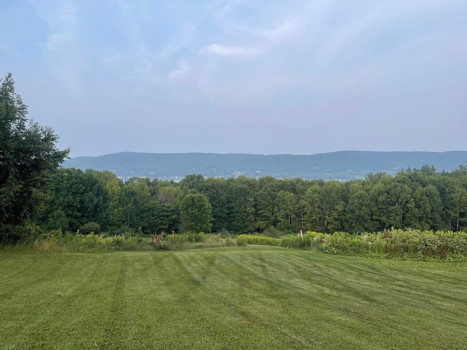 The sprawling backyard is picture perfect with views of Lake Canadarago, open fields, rolling hills, climbing trees, and enough room for a full-scale football game.