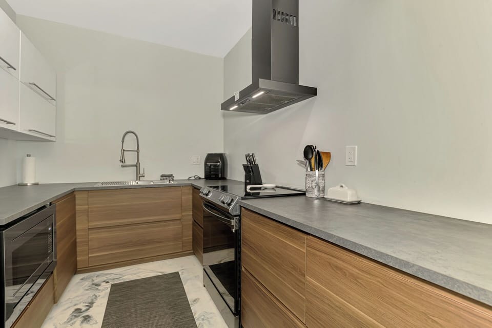 Your modern kitchen features sleek wood cabinets, stainless steel appliances, and ample counter space for cooking memorable meals.