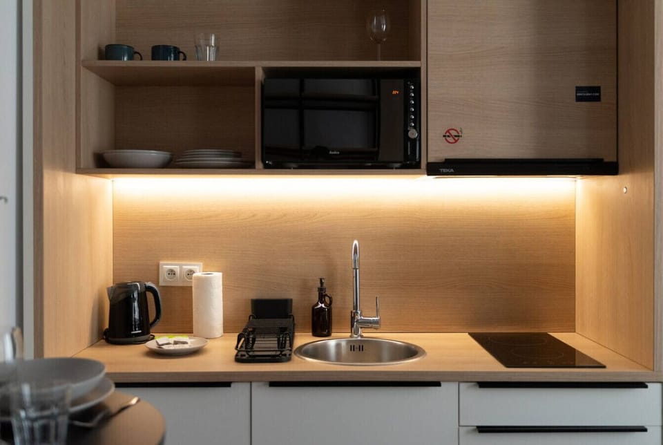 Modern Kitchenette with Induction Hob, Microwave & Dining Space | Book Now with RENTUJEMY.COM