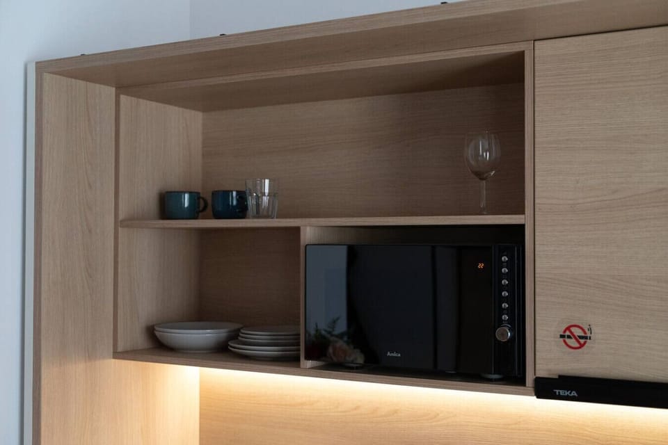 Fully Equipped Kitchenette with Microwave, Dishes & Cooking Essentials | Book Now with RENTUJEMY.COM