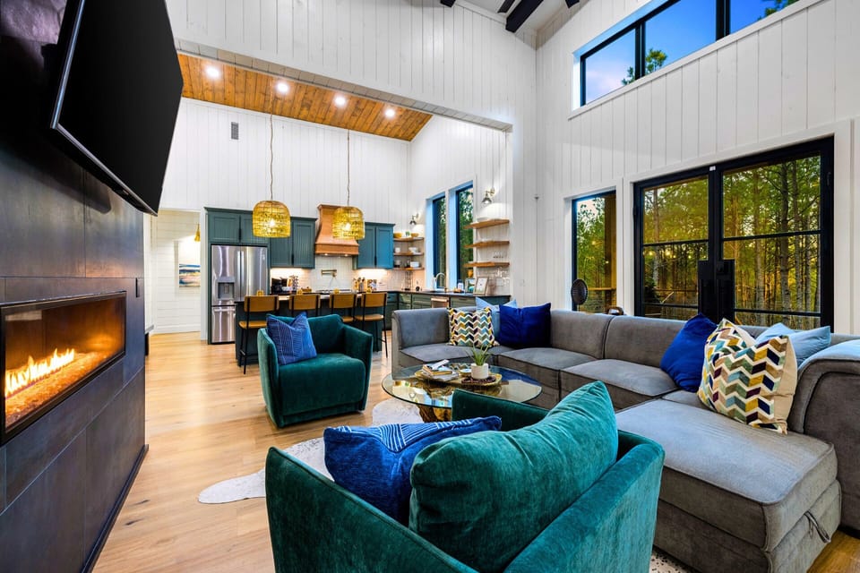 Step inside to soaring ceilings, beautiful wood accents, and a double-sided gas fireplace connecting indoor comfort with outdoor charm.


