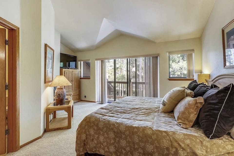 Sink into your plush king bed while enjoying forest views through floor-to-ceiling windows that frame this tranquil mountain retreat.