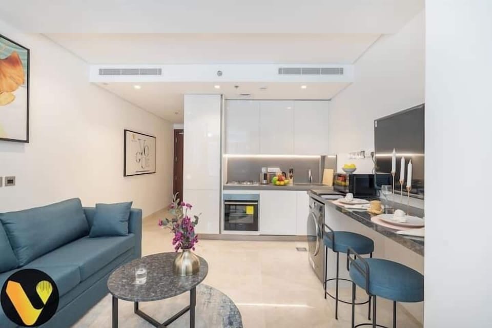 Luxury Apartment, Balcony, City View | Living area | 65-inch Smart TV with cable channels