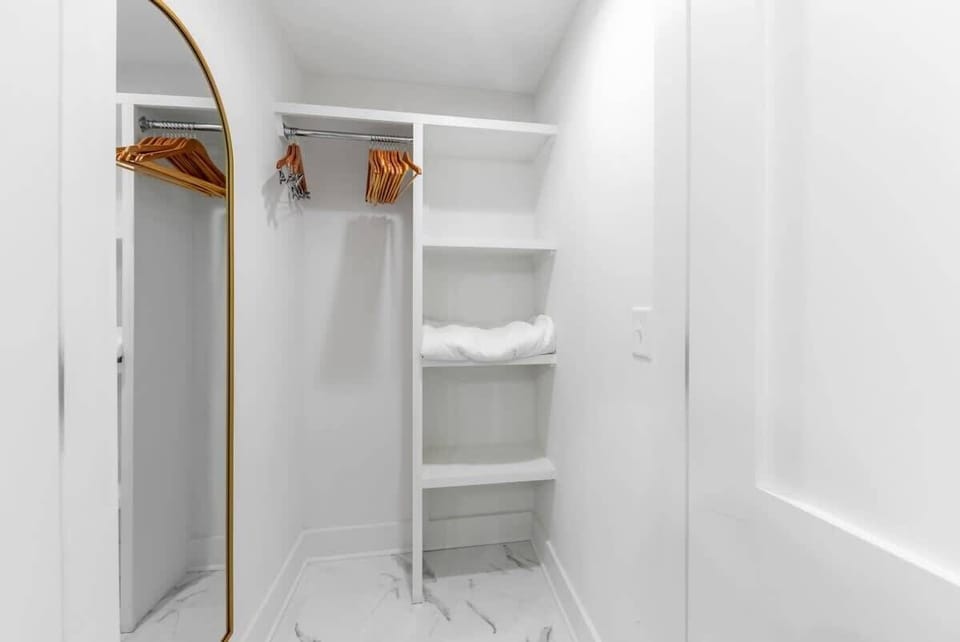 Keep your clothes clean and wrinkle-free in the spacious closet with hangers and shelves