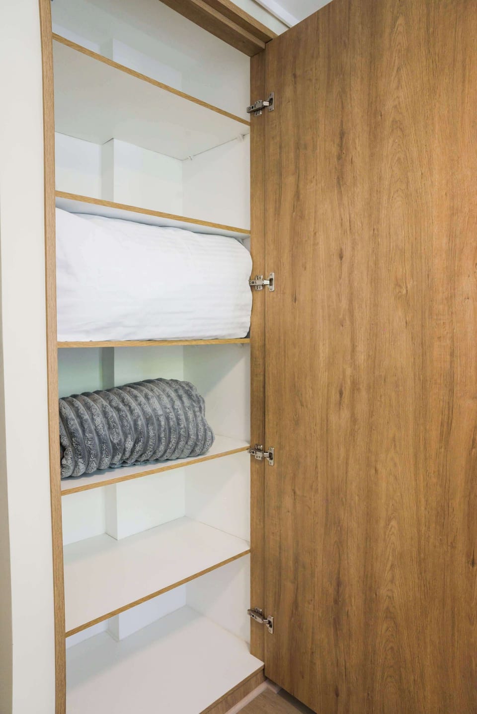 Spacious closet with fresh linens and cozy blankets for your comfort.