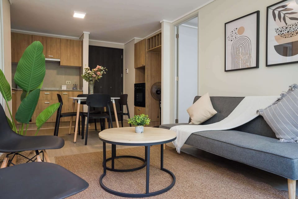 Cozy and stylish living area with modern decor and ample seating, perfect for relaxation or dining.