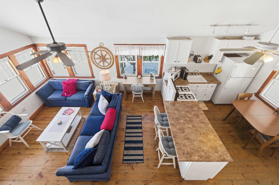 The open layout lets the whole family spread out, with the living area, dining table, and kitchen all flowing together under the vaulted ceiling.
