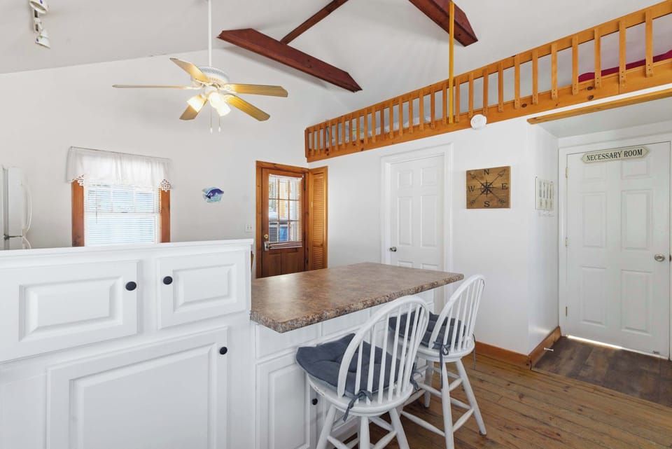 From this angle you can see how the breakfast bar, kitchen, and loft all share the same open space under the vaulted ceiling.