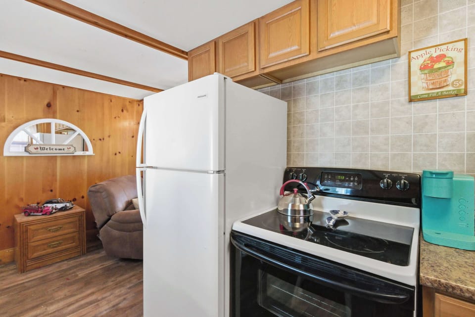 The kitchen has a full-size fridge, electric range, and enough counter space to actually cook a real meal.