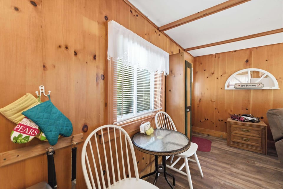The small table and chairs tucked into the knotty pine corner make for a quiet spot for morning coffee before the rest of the cottage wakes up.