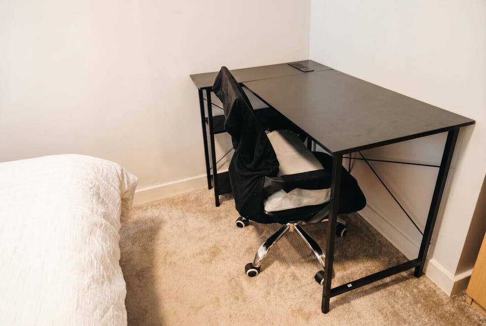 Dedicated desk and ergonomic chair make remote work or late planning easy.