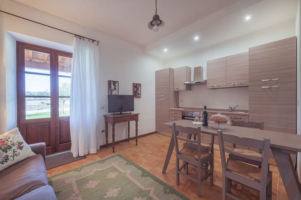 Apartment, 1 Bedroom, Non Smoking, Ground Floor (ULIVO) | Private kitchen | Full-size fridge, stovetop, cookware/dishes/utensils, dining tables