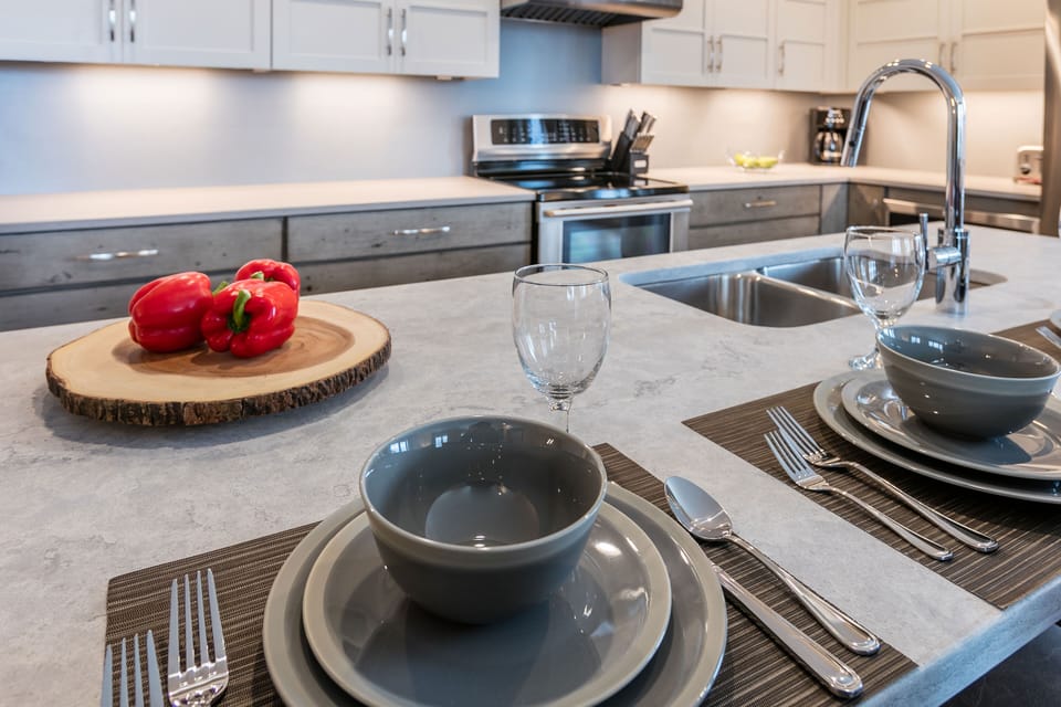 The kitchen and dining setup create a stylish spot for casual meals, morning coffee, or gathering before hitting the mountain.