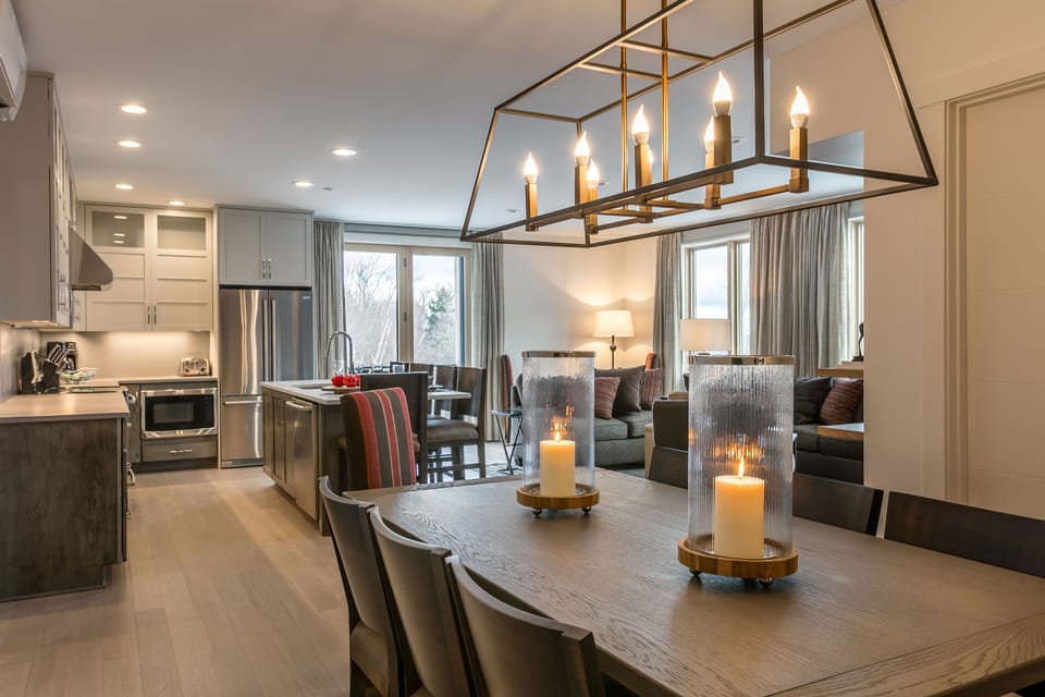 The open-concept living and dining area is filled with natural light, providing a welcoming space to relax, dine, and spend time together.