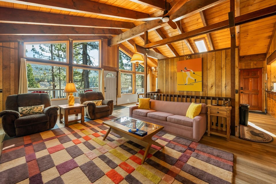 Wall-to-wall windows bring in natural light and beautiful pine tree views year-round.