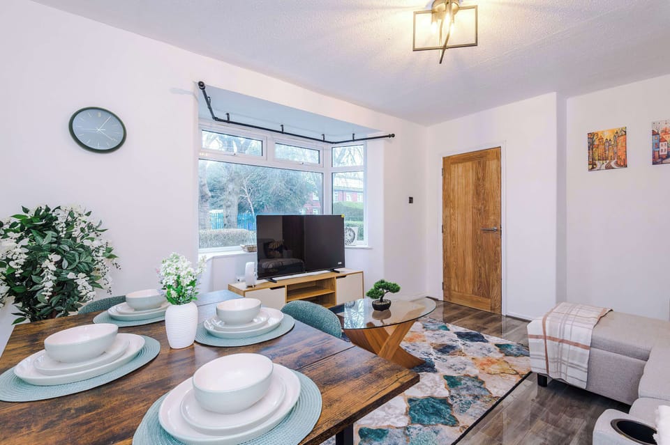 Living Room: Bright and inviting space with modern decor and views of the lush garden!