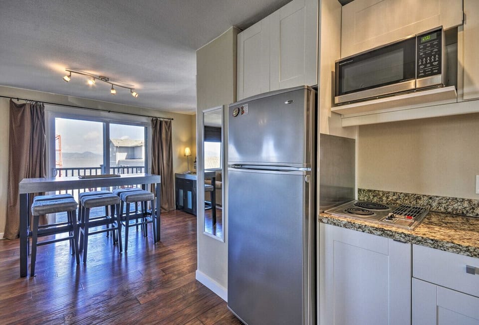Kitchen | Stainless Steel Refrigerator | Granite Counters & Bar Seating