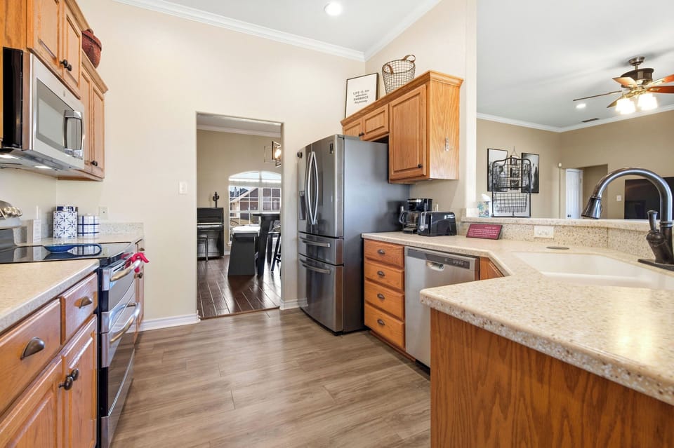 A fully stocked kitchen with appliances is ready for you.