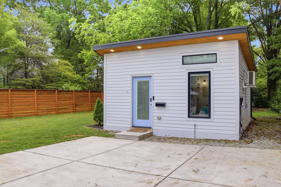 Modern private guest house with fenced yard and peaceful tree-lined setting
