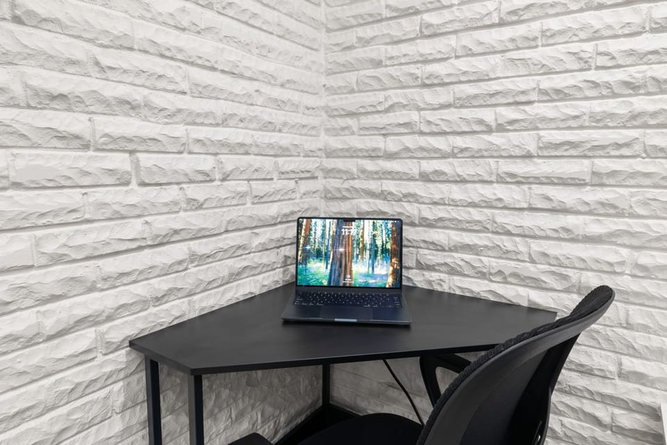 Dedicated workspace with sleek desk and modern stone accent walls
