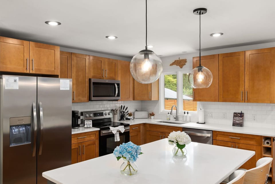 Bright modern kitchen with island seating and stainless appliances