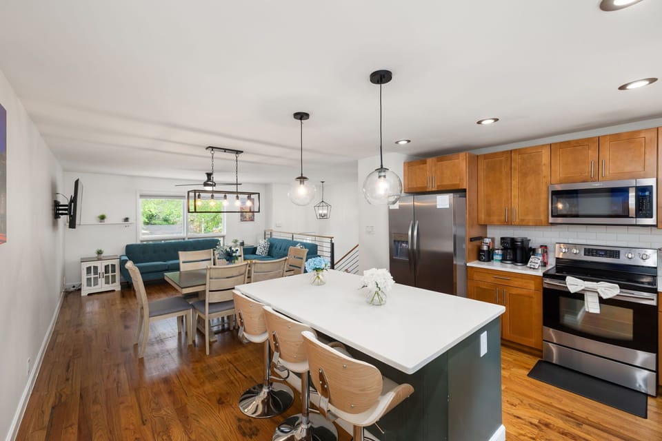Bright open kitchen with island seating and cozy living area