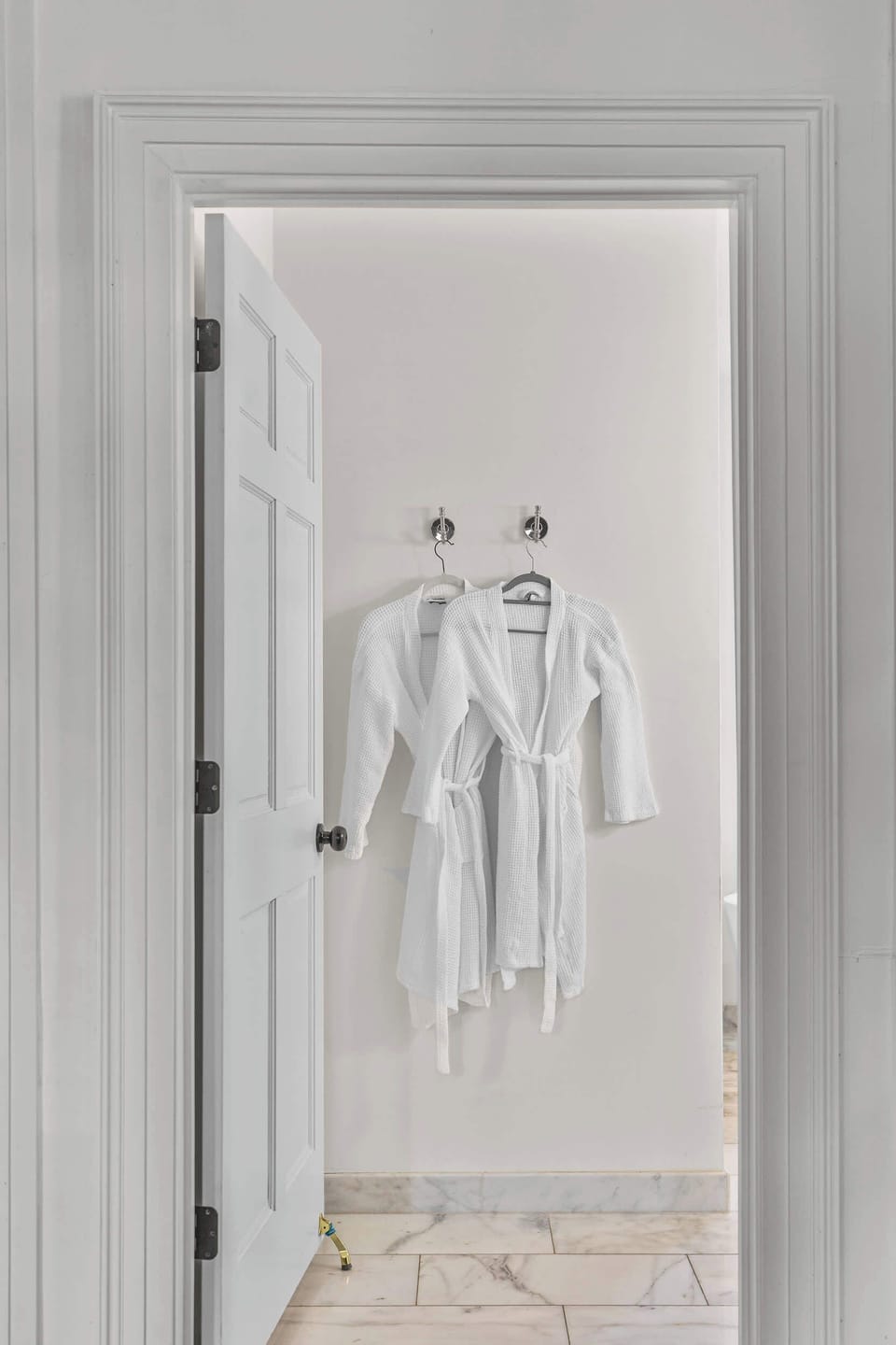Bathroom #1: Indulge in a spa-like retreat featuring a soaking tub, walk-in shower, dual vanities, plush bathrobes, and elegant luxury finishes.