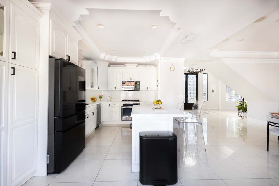 Fully equipped kitchen with dishwasher, stove, and prep space for cooking.