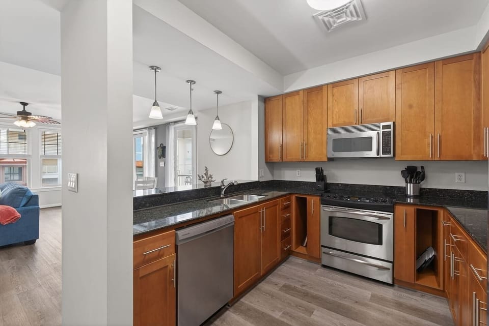 Open kitchen with double sink and breakfast bar—stay connected while cooking and enjoying the living space.