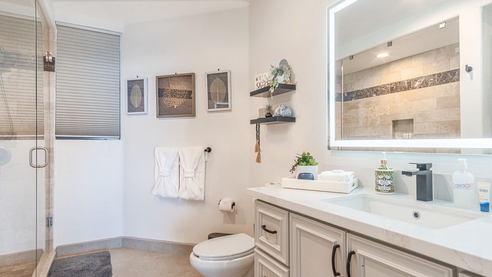 ample space in the bathroom. Custom lighted mirror.