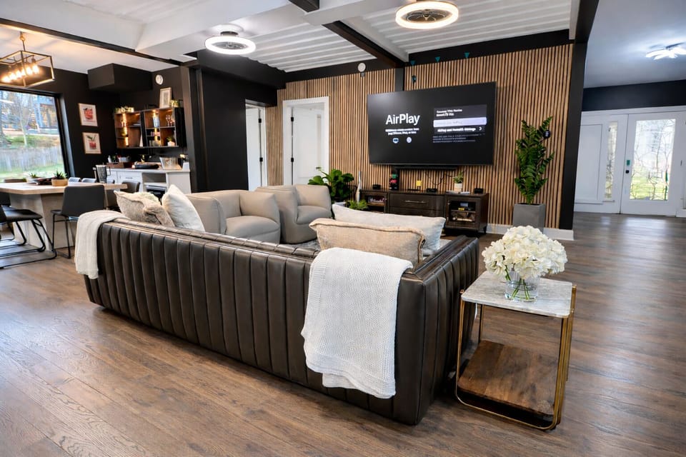 Incredible Living Room with Stunning Leather Sofa, Leather Swivel Chairs, and High Definition 85" Smart TV with Vizio Sound System.