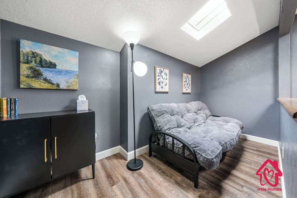 Cozy room with futon and natural light.