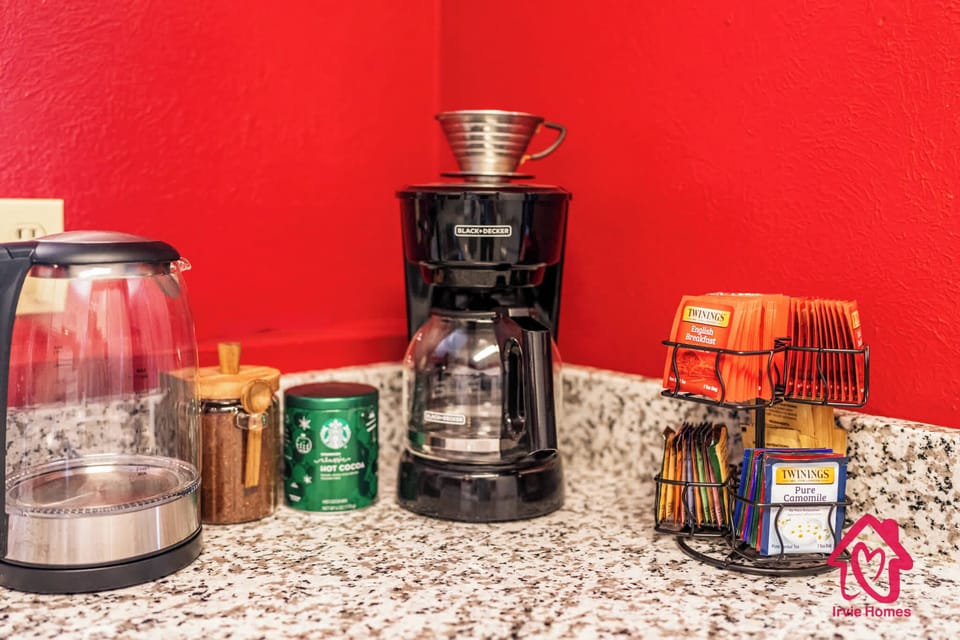 Stylish beverage station with coffee maker and tea selection.