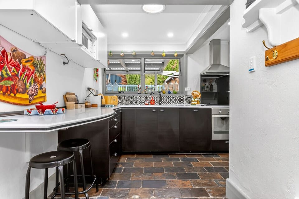 Kitchen workspace with natural light and garden views.
