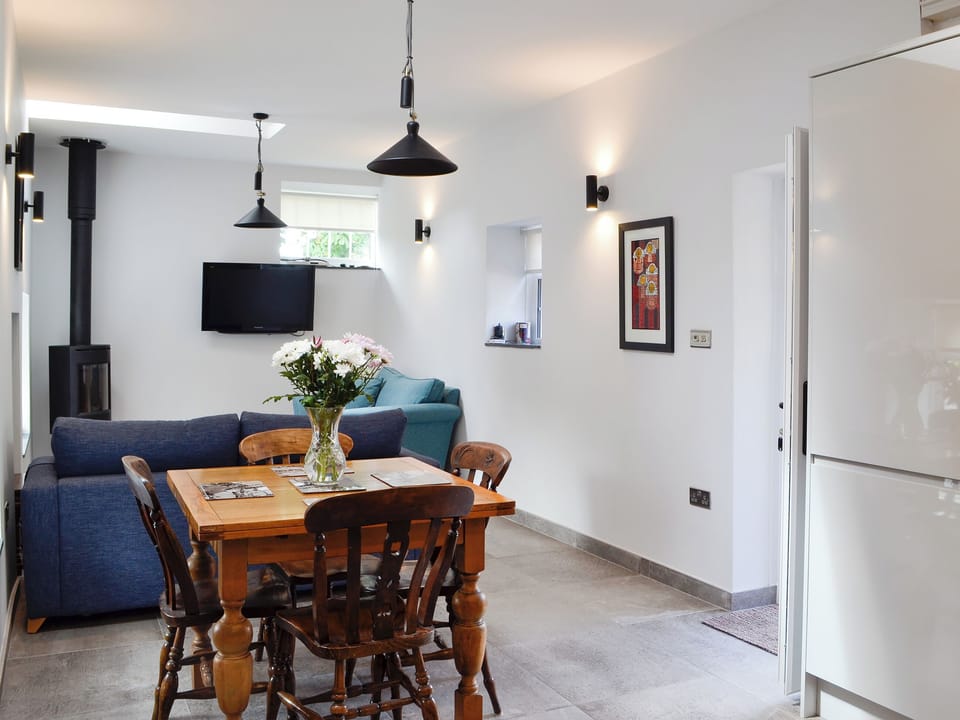 Living area with dining table and chairs | Bwythn Y Saer, Plas Cilybebyll, near Pontardawe