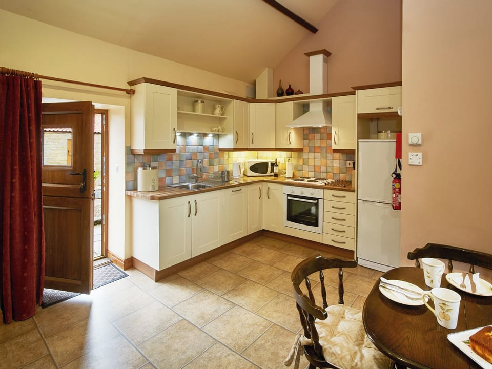 Well-equipped fitted kitchen within the open-plan design | Hindburn - Rawcliffe House Farm, Stape, near Pickering
