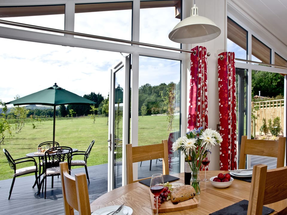 Light and airy dining area with access to the decking | Willow Lodge - South Downs Lodges, Hassocks