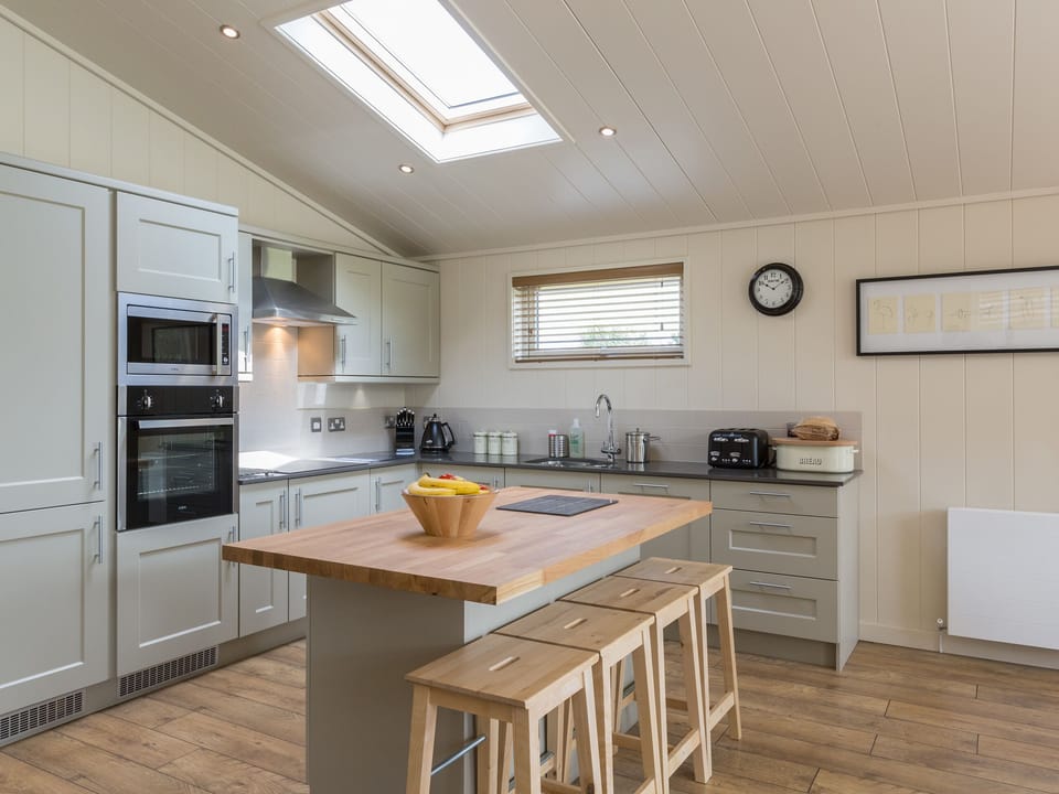 Kitchen area with island breakfast bar | Oak Lodge - South Downs Lodges, Hassocks