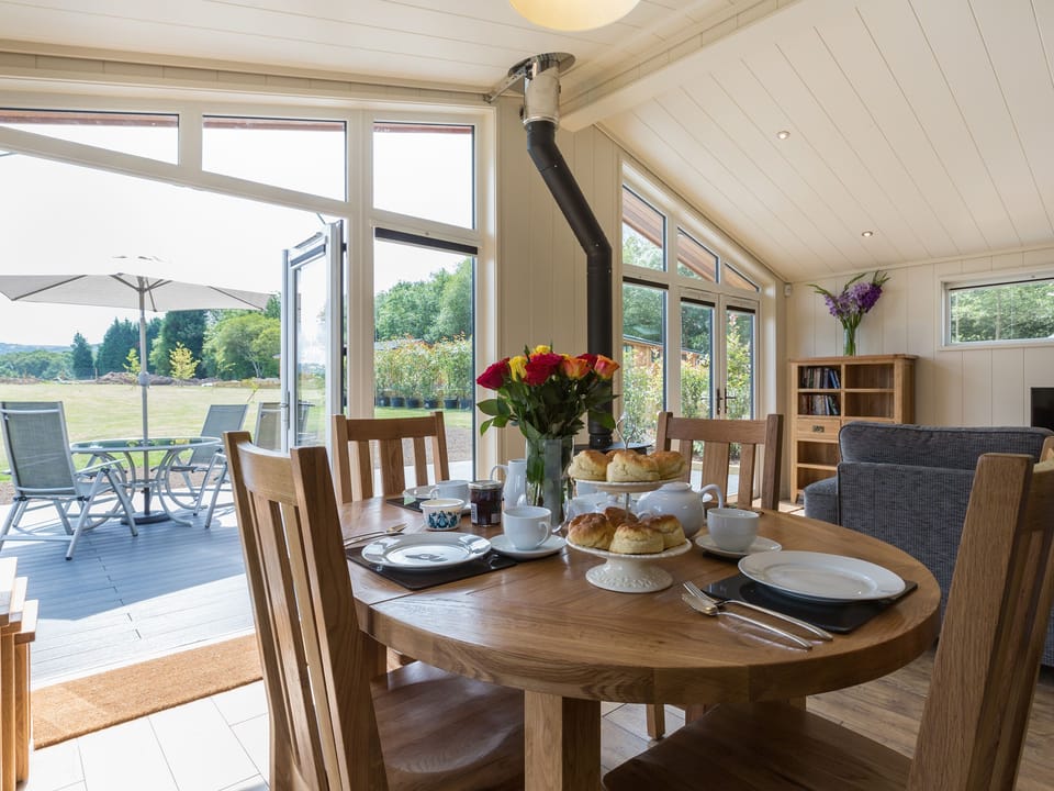 Dining area overlooking the decked area | Oak Lodge - South Downs Lodges, Hassocks