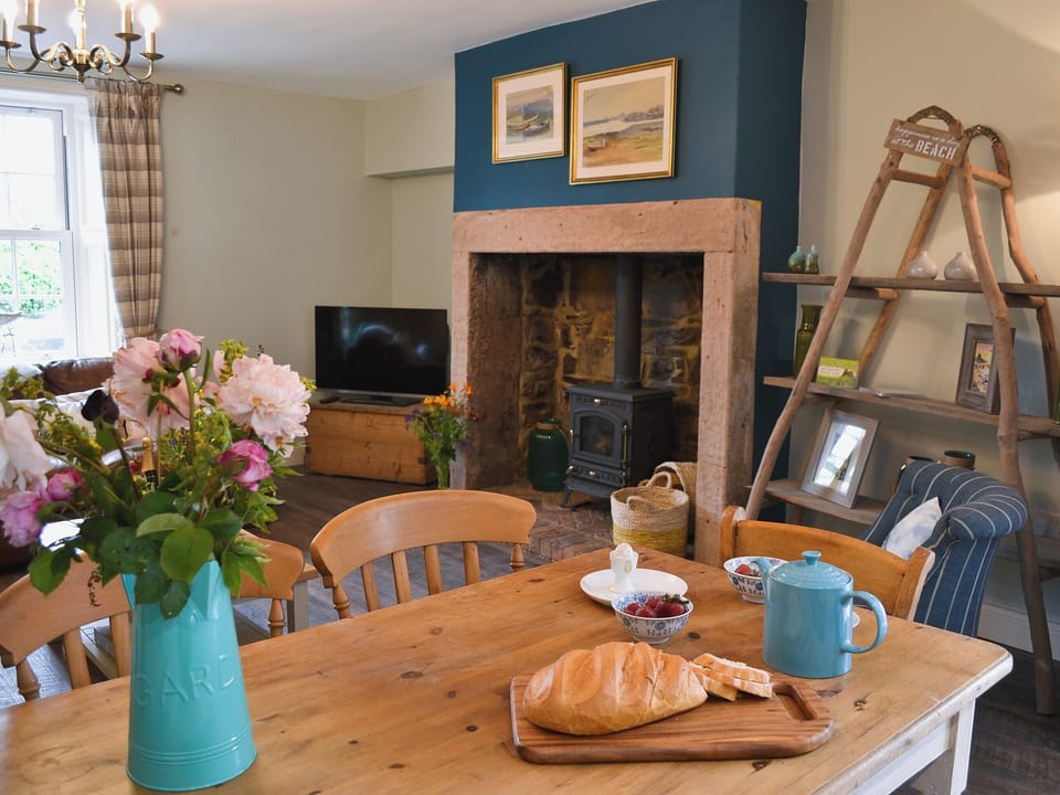 Lounge and dining area with wood burner | Rose Cottage, Beadnell